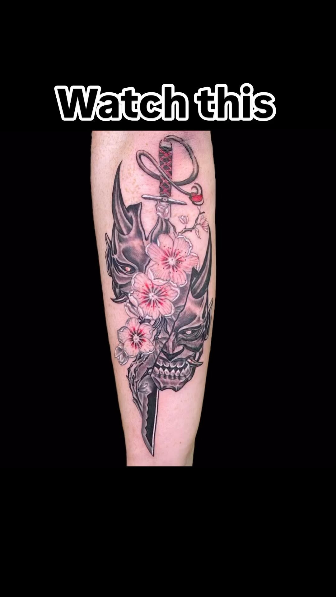 Bold black-and-gray dagger intertwined with pink cherry blossoms
