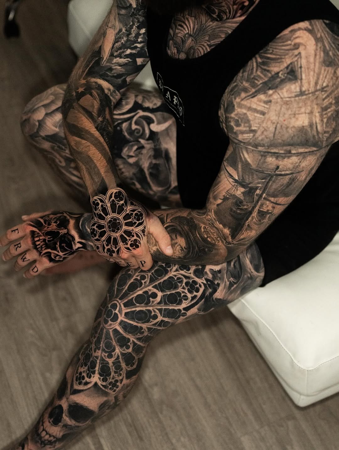 Intricate blackwork sleeve with mandala floral on hand.