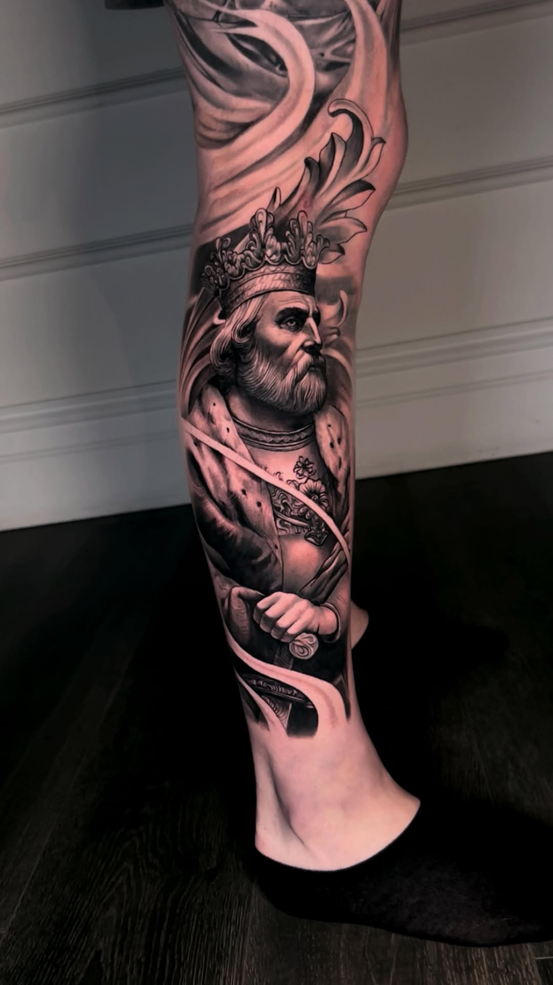 Hyper-detailed black-and-gray realism portrait of a regal king.