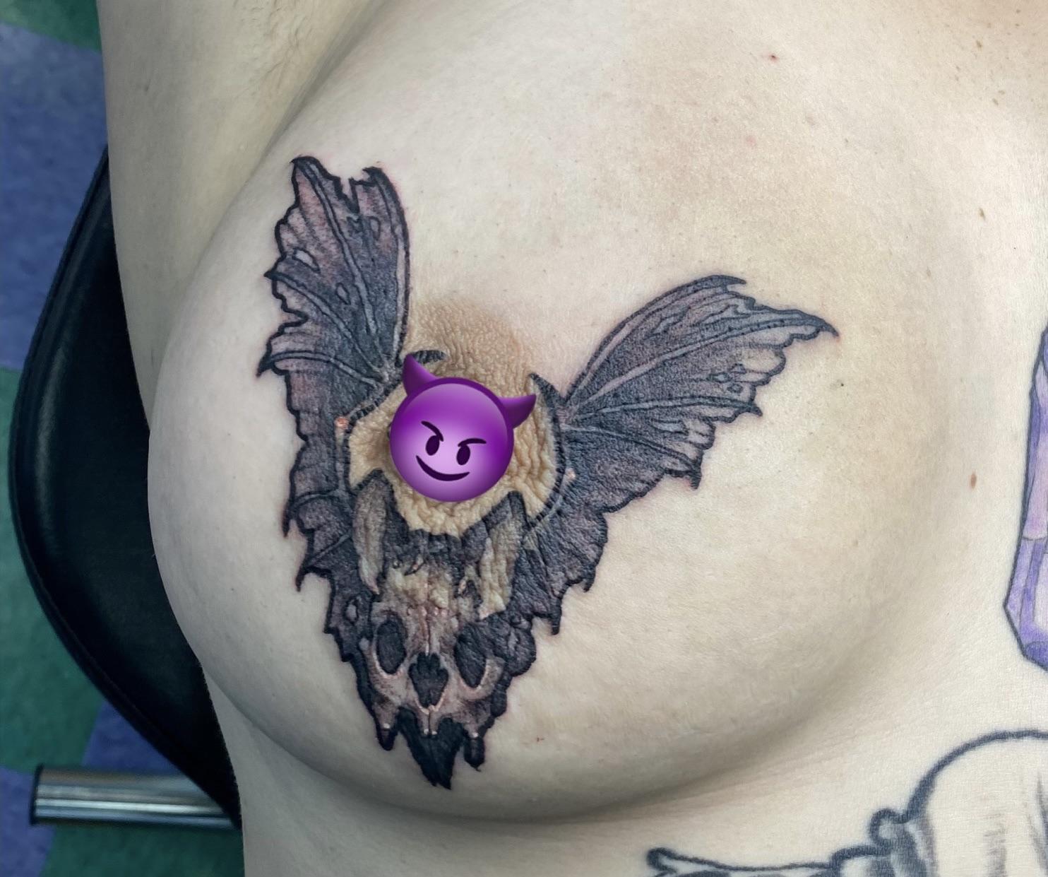 Bold blackwork moth with ragged, textured wings and subtle peach highlight