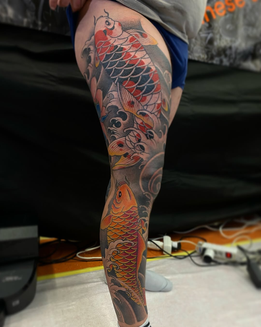 Vibrant koi fish sleeve with bold waves and shading.