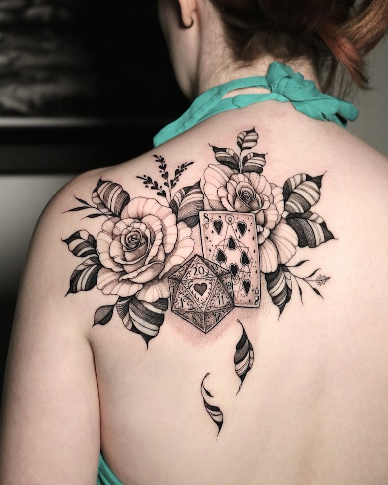 Elegant black-and-gray floral bouquet entwined with cards and d20