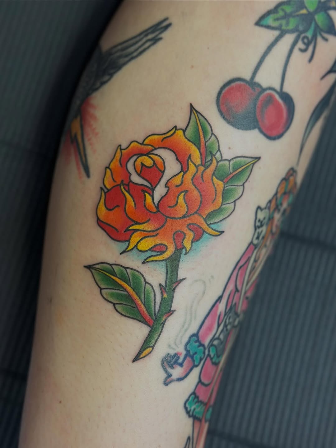 Vivid neo-traditional orange rose with bold black outlines.