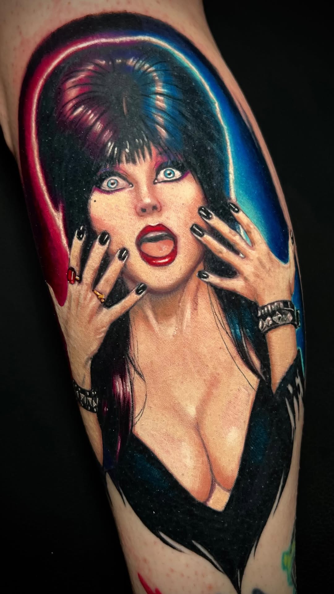 Vivid neon-lit portrait of a shocked, red-lipped femme.