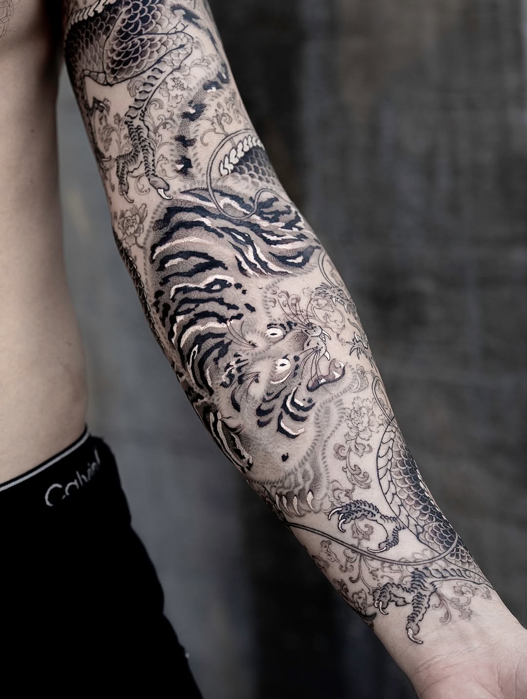 Intricate Japanese dragon-tiger sleeve in black-gray ink