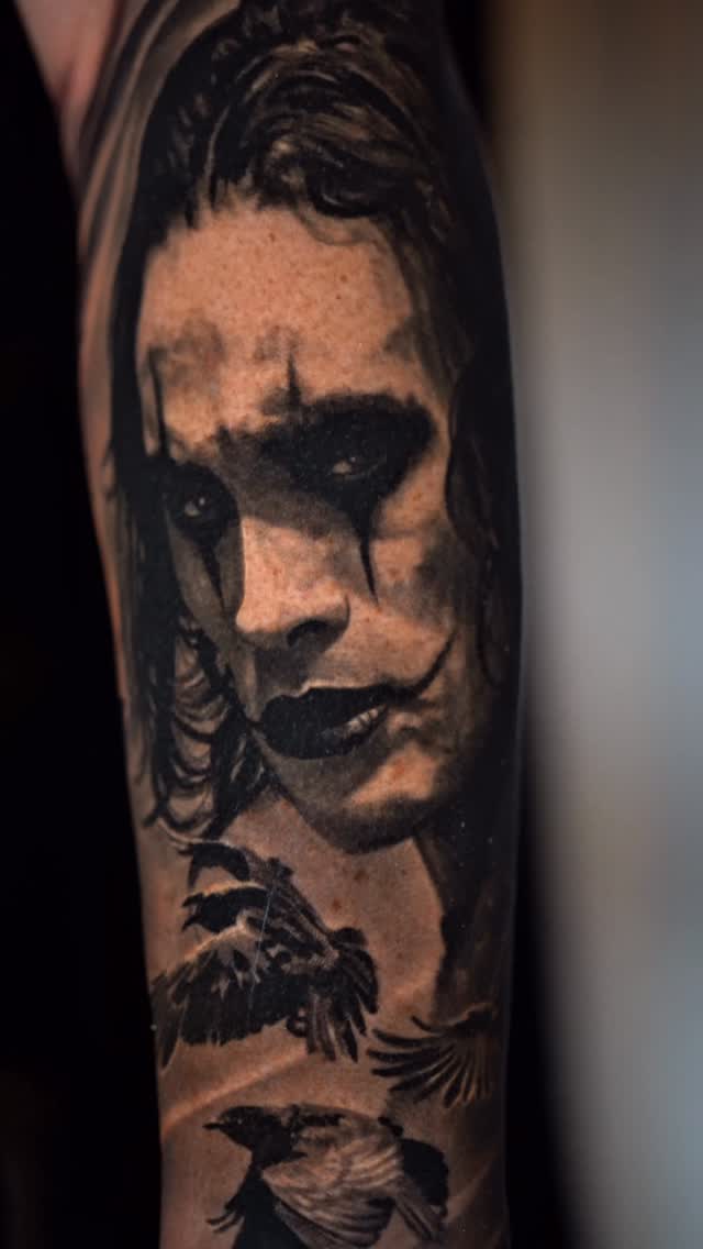 Moody grayscale portrait with smeared makeup and roaming ravens.