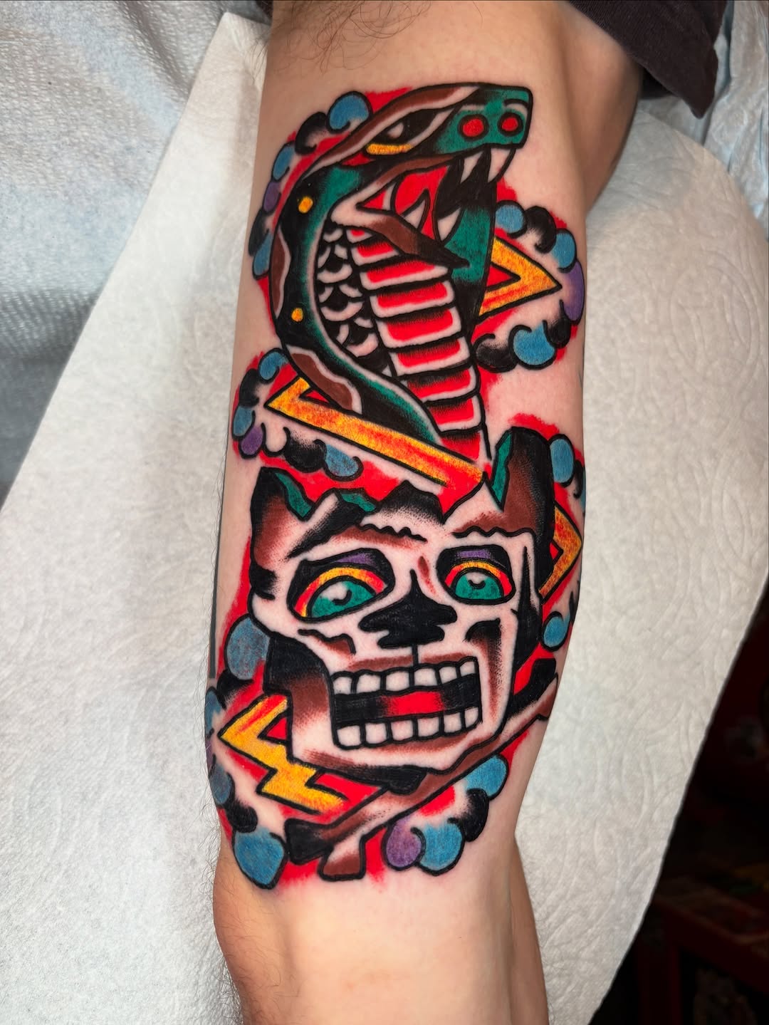 Vivid neo-traditional skull with neon serpent and bolts