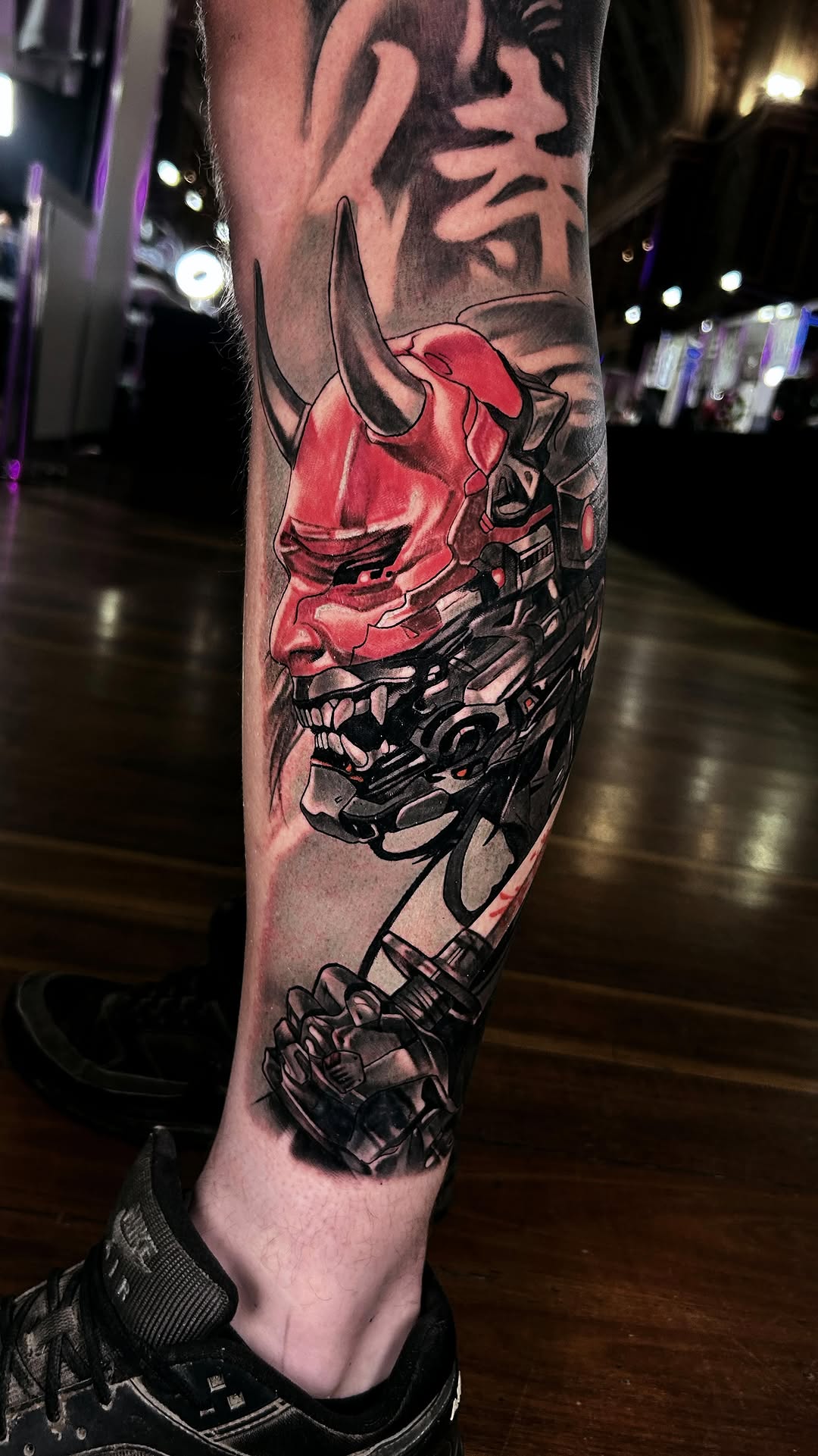 Bold red oni mask fused with black biomechanical machinery