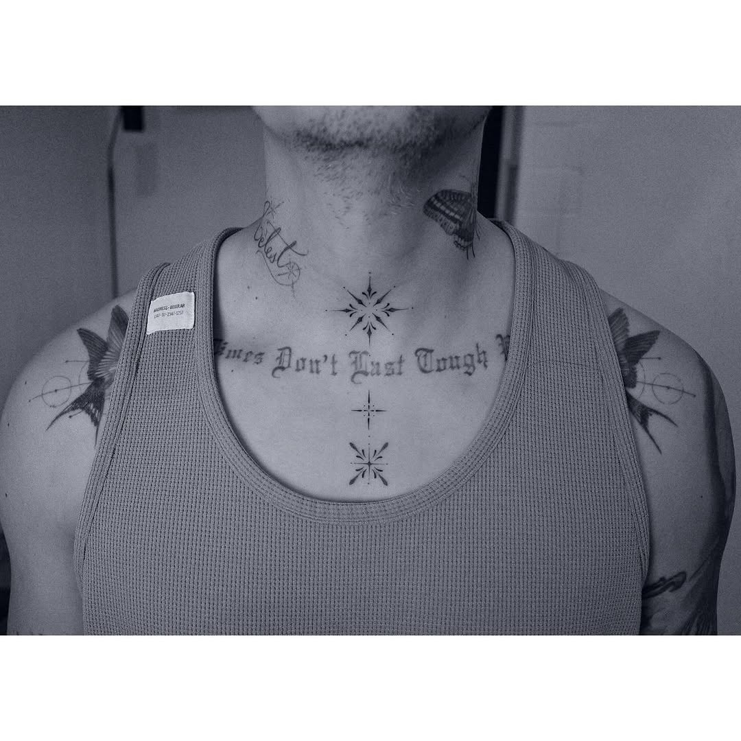 Bold blackwork chest script with starburst accents