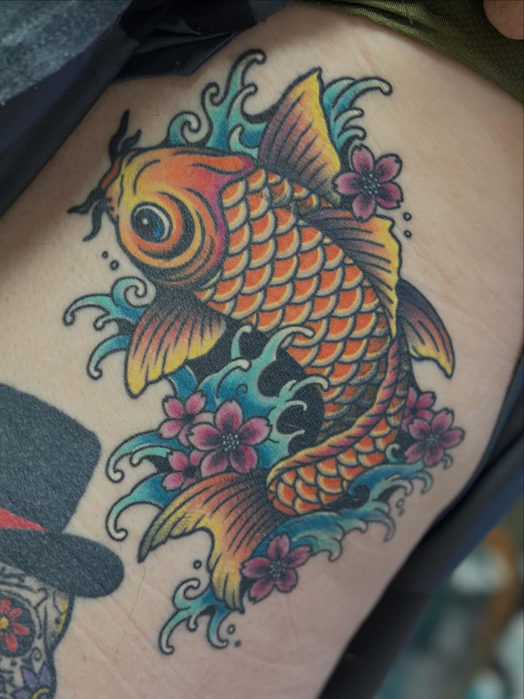Vibrant koi in bold Japanese-neotraditional style with blossoms