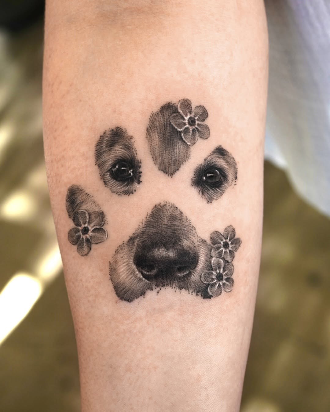 Fingerprint paw print with surrounding blossoms in dotwork.