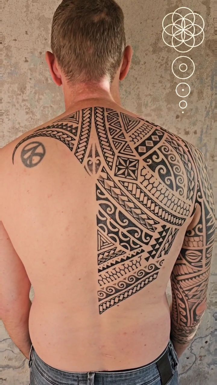 Massive Polynesian backpiece featuring dense geometric tribal patterns