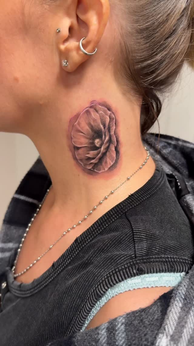 Realistic pink flower tattoo on neck with soft shading