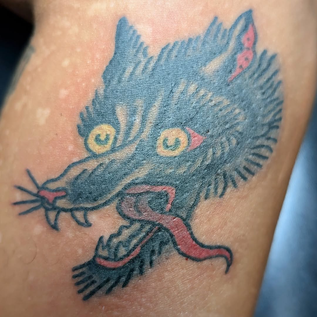 Cartoonish blue wolf head with tongue out