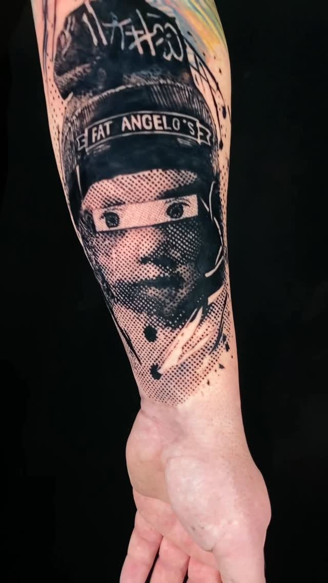 High-contrast halftone portrait on forearm with dotted shading