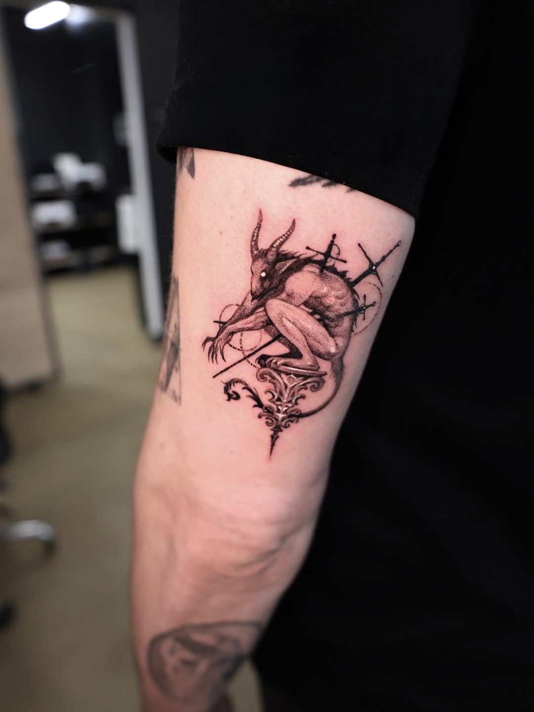 Dark fantasy deer-demon perched atop an ornate Gothic crest.