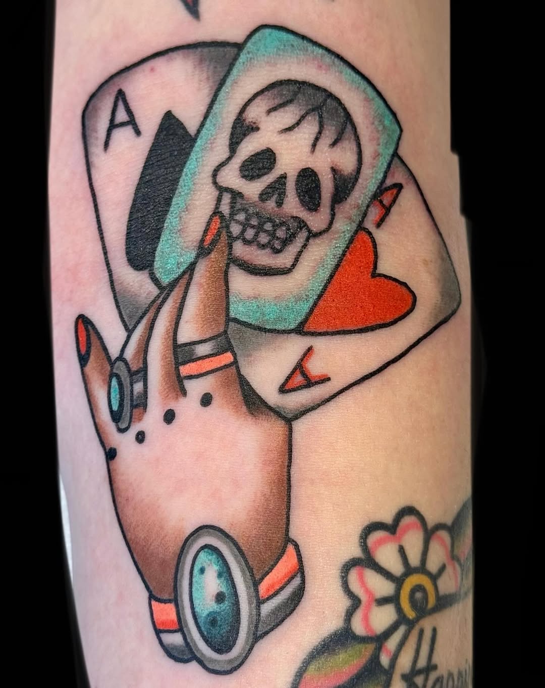 Bold neo-traditional hand-held skull within playing-card frame