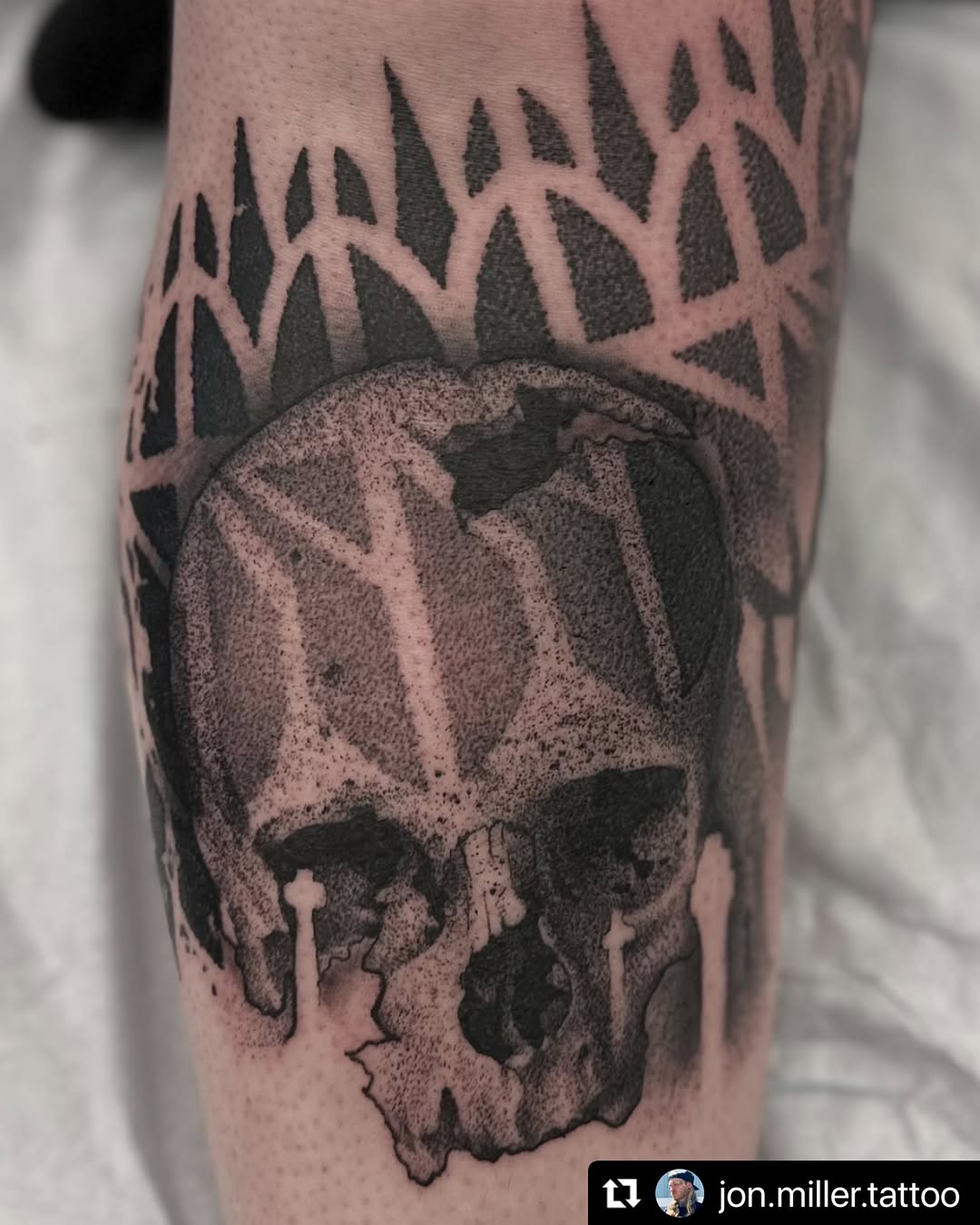 Stippled skull with bold blackwork and jagged border