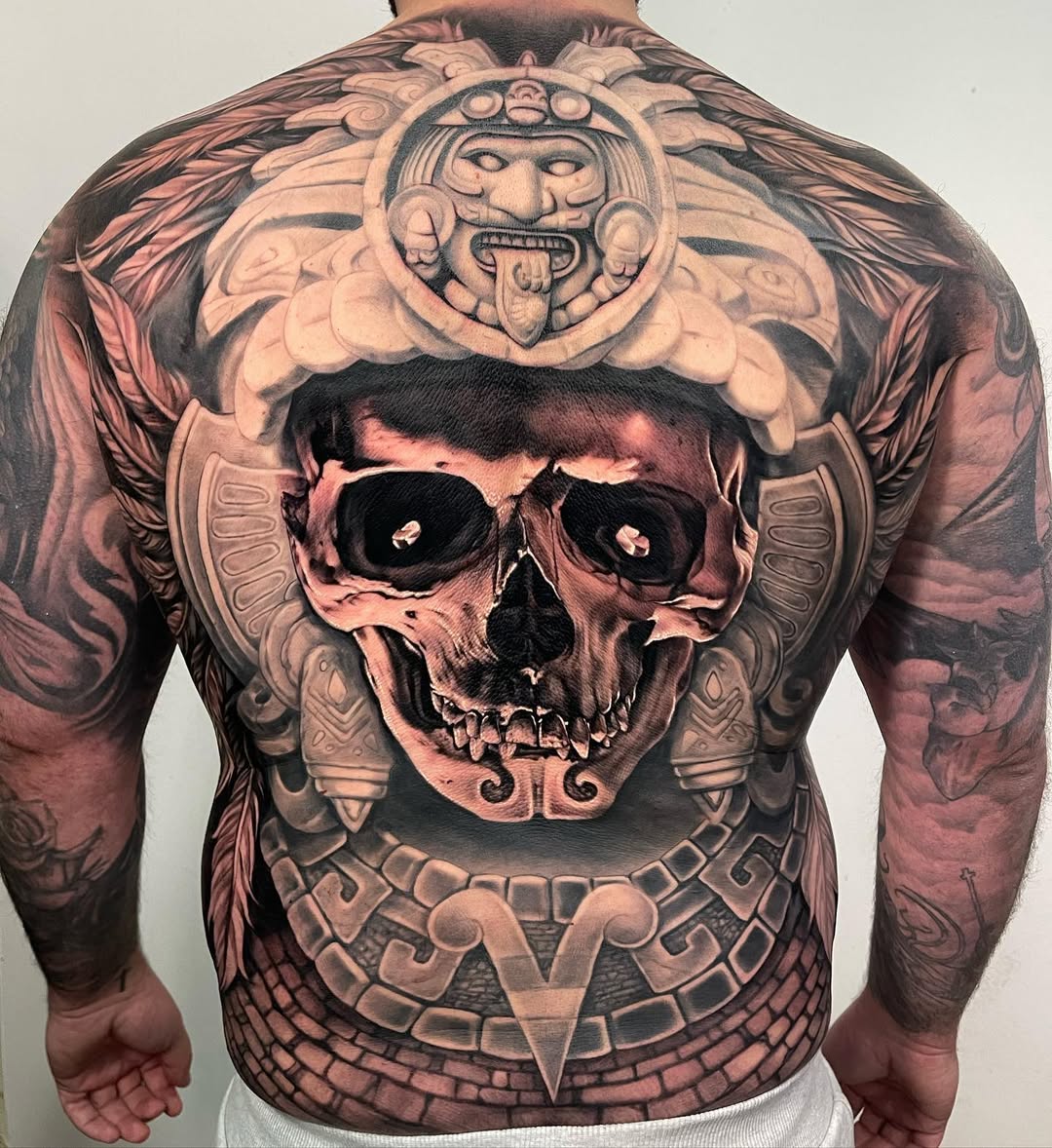 Monumental Mayan-inspired backpiece featuring skull centerpiece and glyphs