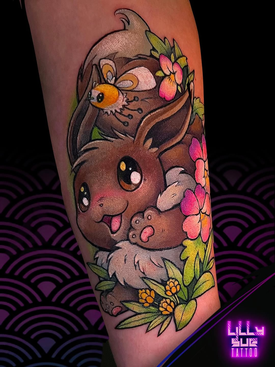 Charming Eevee tattoo framed by bright hibiscus flowers