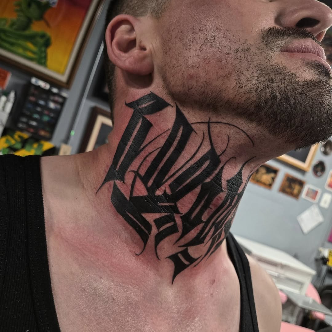 Bold blackwork neck piece with interwoven geometric strokes