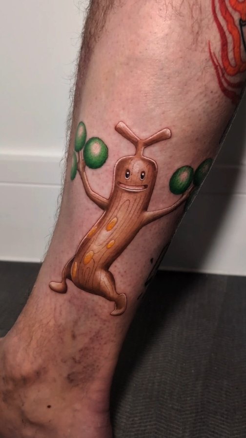 Playful 3D-style Sudowoodo Pokémon tattoo on calf