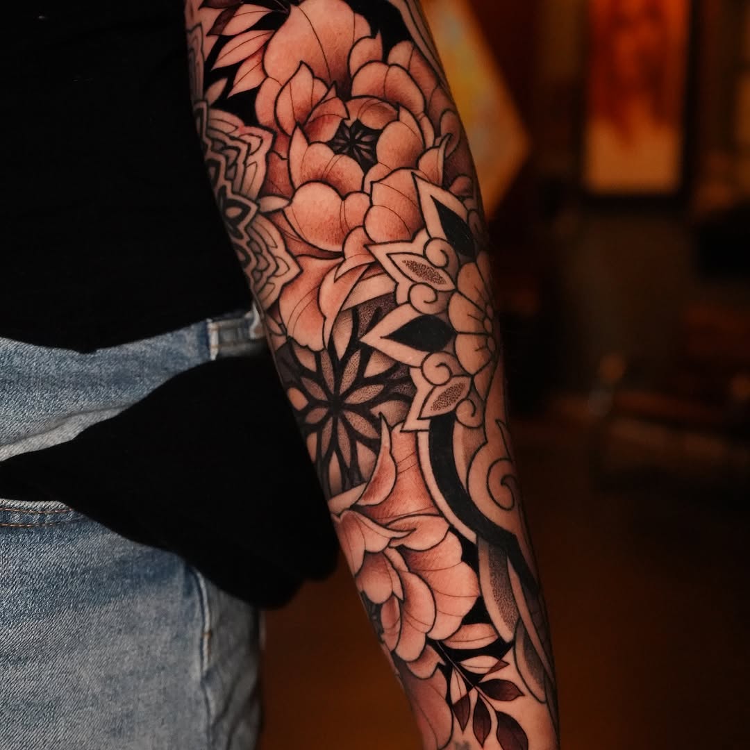 Intricate blackwork floral sleeve with bold outlines