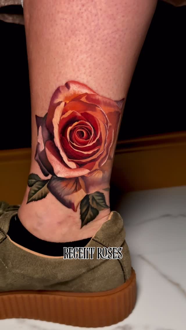 Lifelike red-rose ankle tattoo with lush leaves