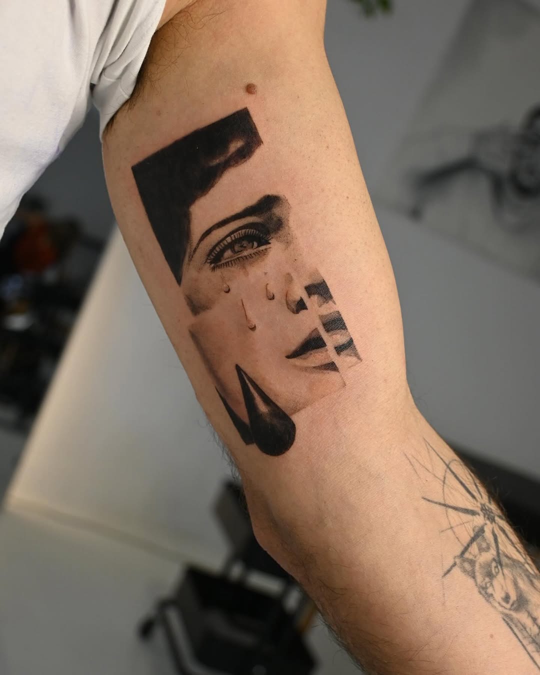 Monochrome surreal face with geometric shards and teardrops