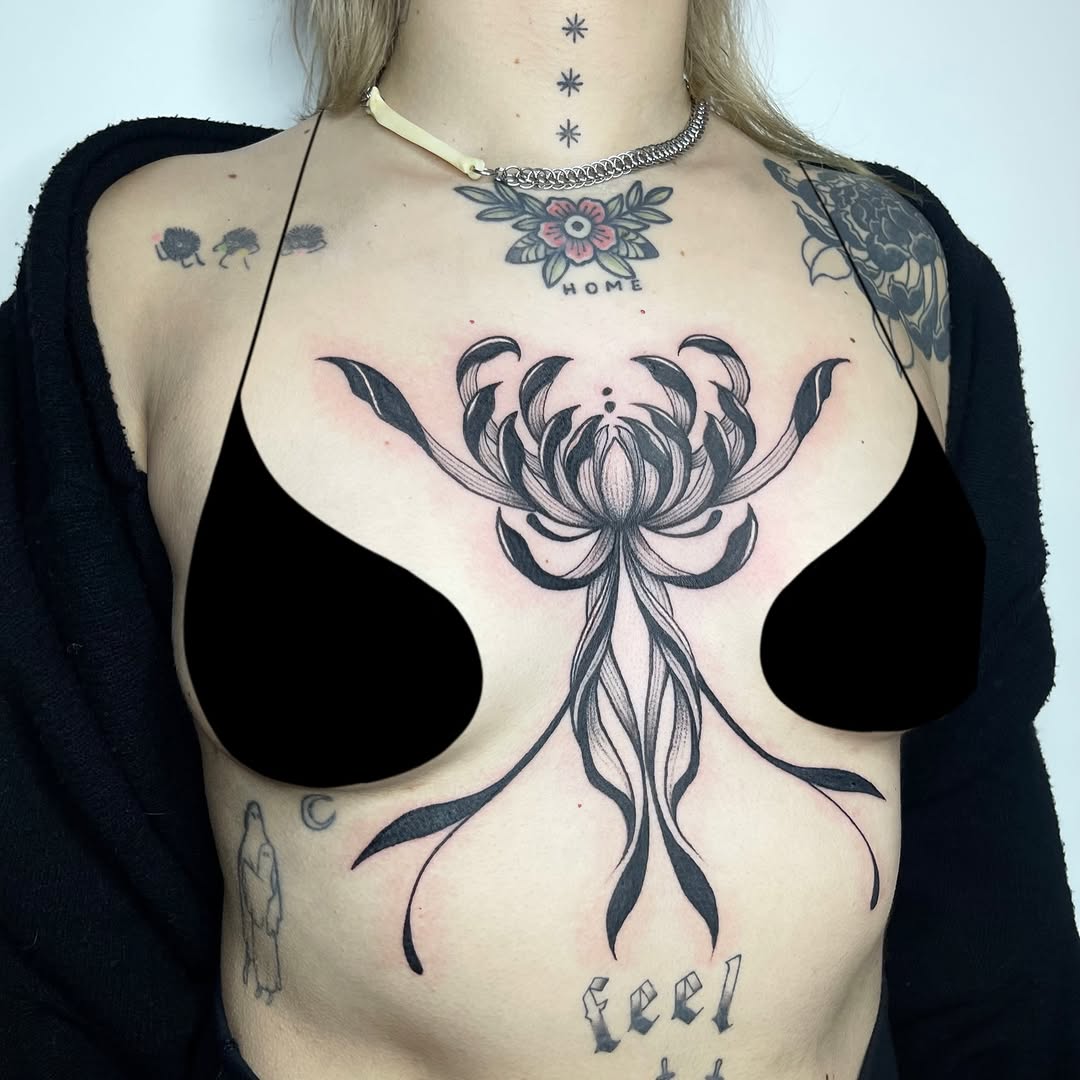 Bold sternum-centered floral design with curling ribbons