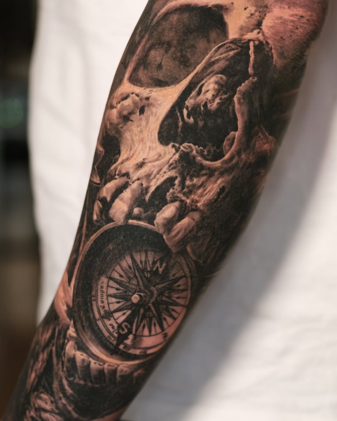 Dark black-and-gray skull entwined with compass, hyper-realistic.