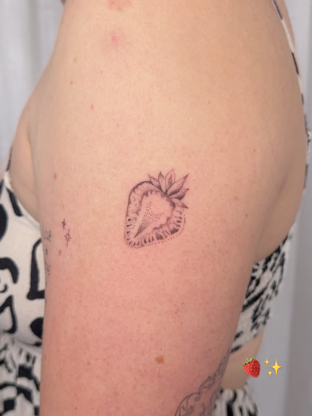 Tiny dotwork strawberry with crisp linework, minimalist charm