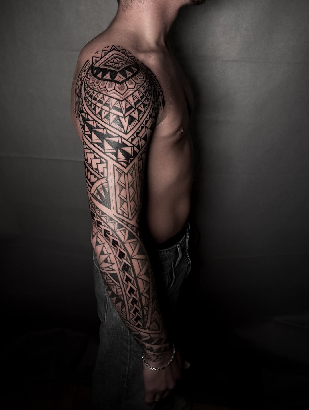 Intricate Polynesian tribal sleeve with bold geometric patterns