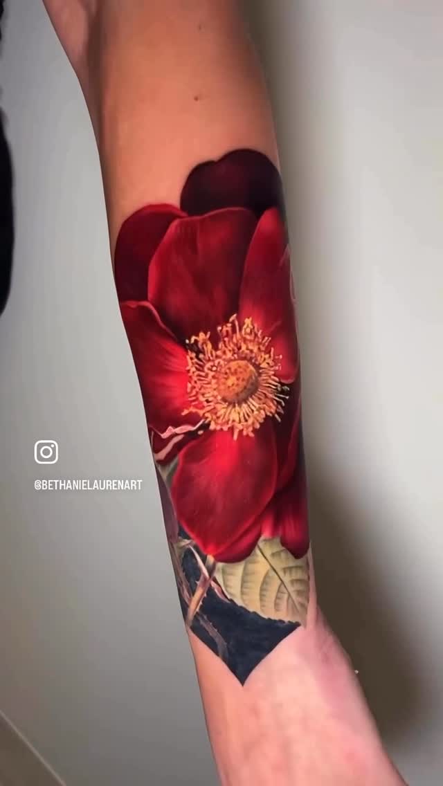 Hyper-realistic red floral sleeve with lush green leaves
