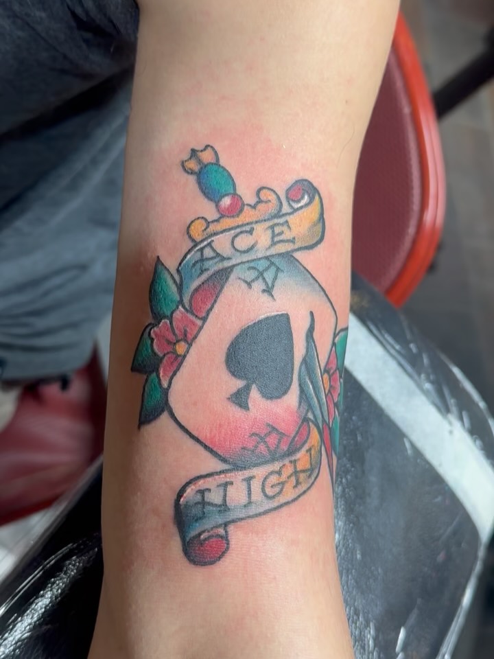 Vivid neo-traditional spade crest with ribbons and roses