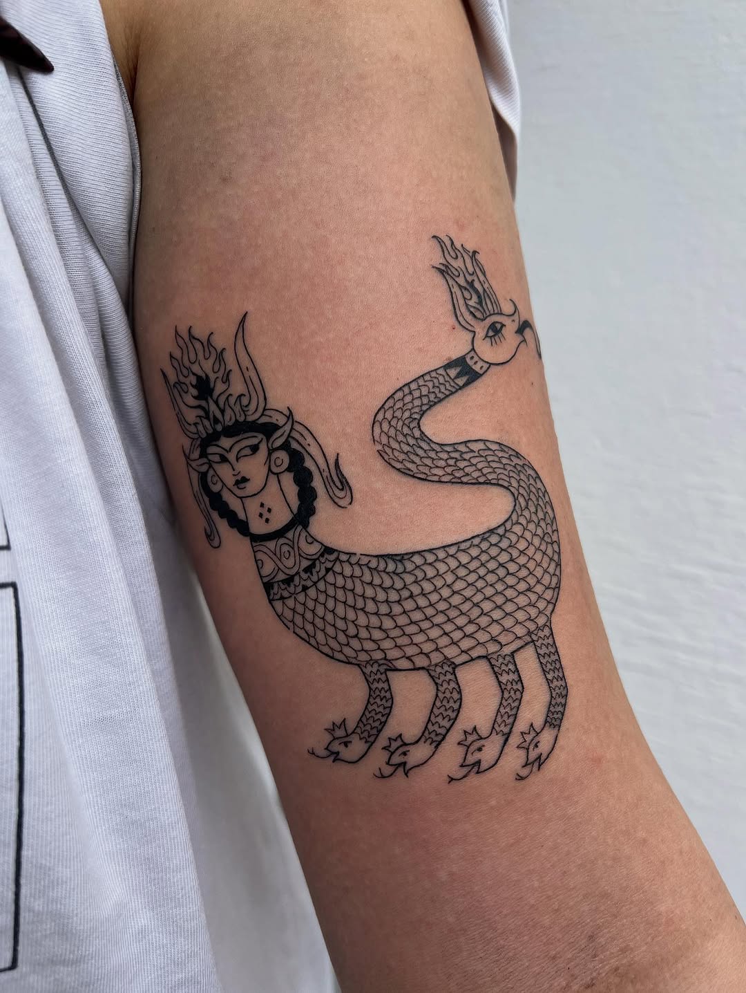 Shahmaran-inspired linework: serpentine scales, regal female head