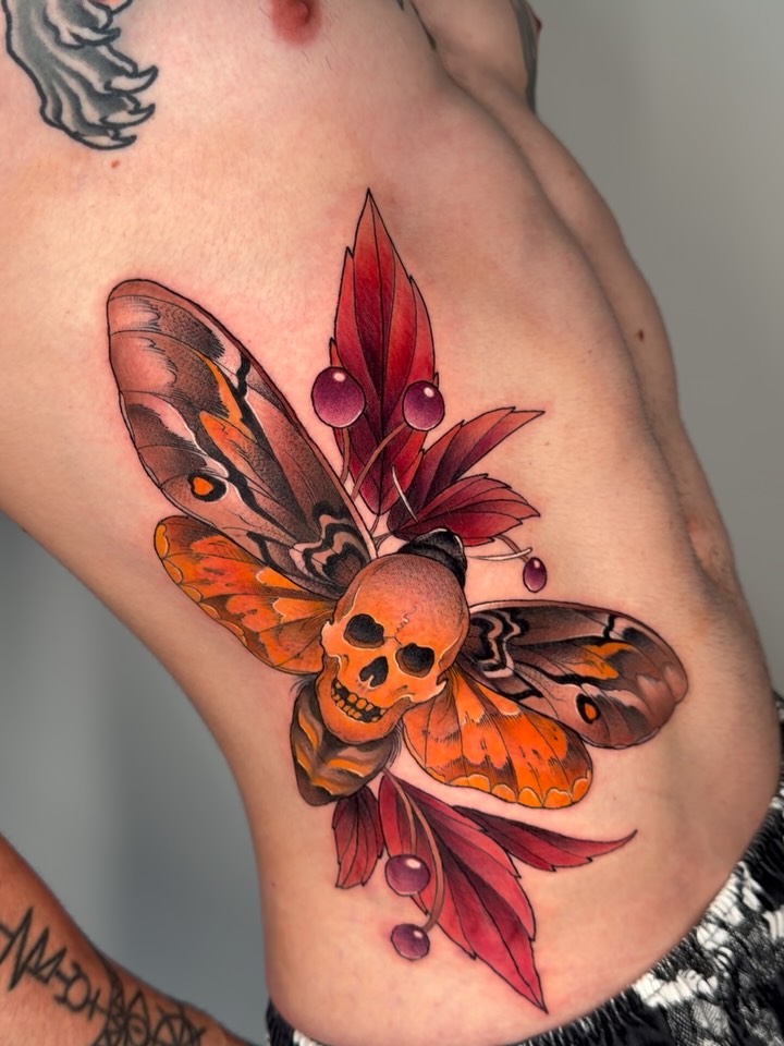 Bold neo-traditional skull-butterfly with orange wings