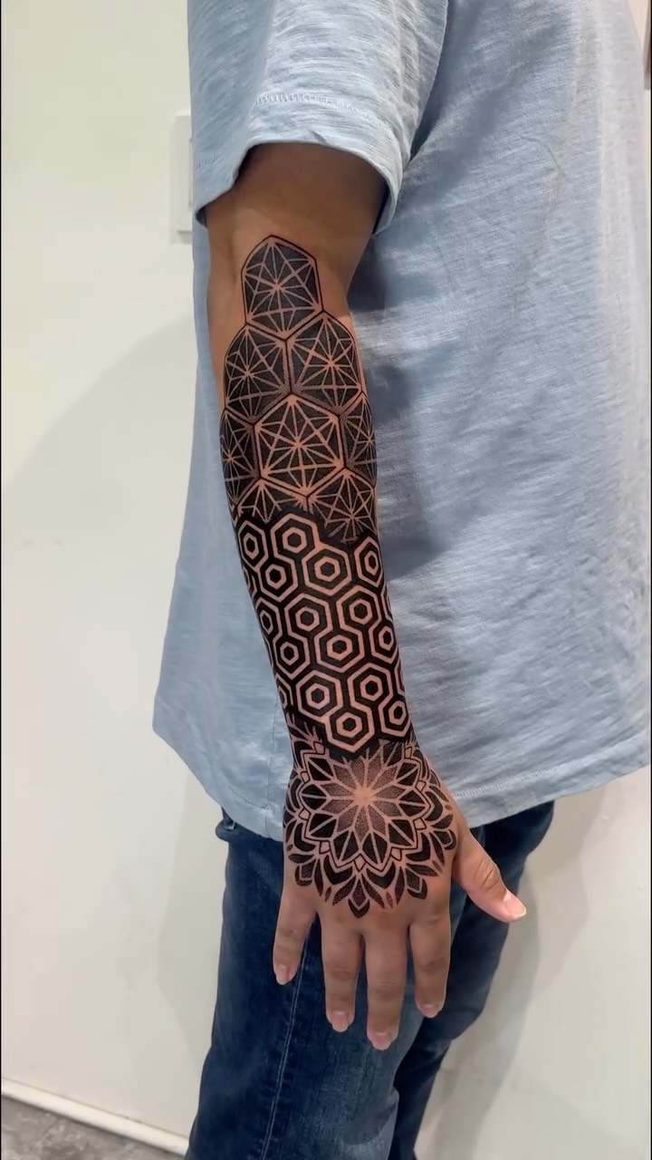 Geometric forearm sleeve with interlocking polygons and mandalas