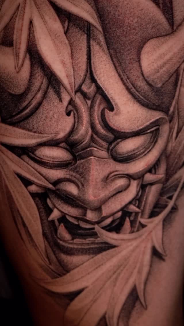 Monumental black-and-gray Hannya mask with fierce, flowing shading