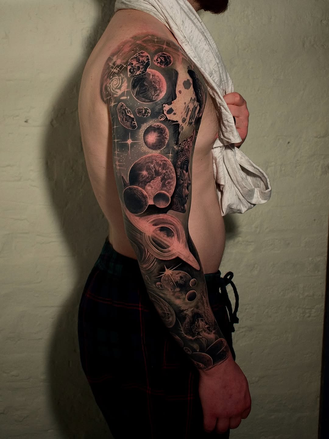 Monumental cosmic sleeve in moody black-and-gray tones