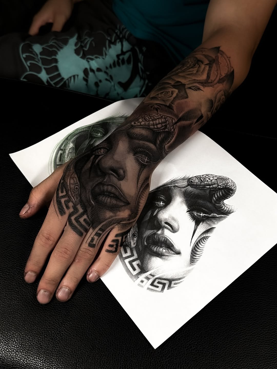 Hyper-detailed black-and-gray portrait on forearm with geometric accents