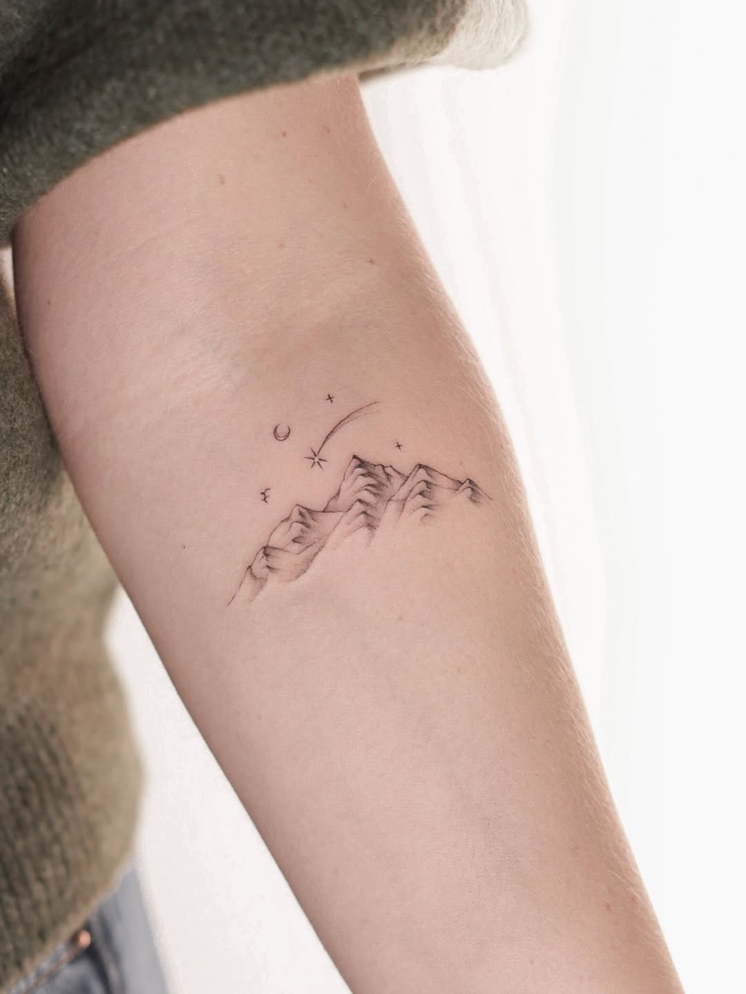 Minimalist mountain range with crescent moon and stars