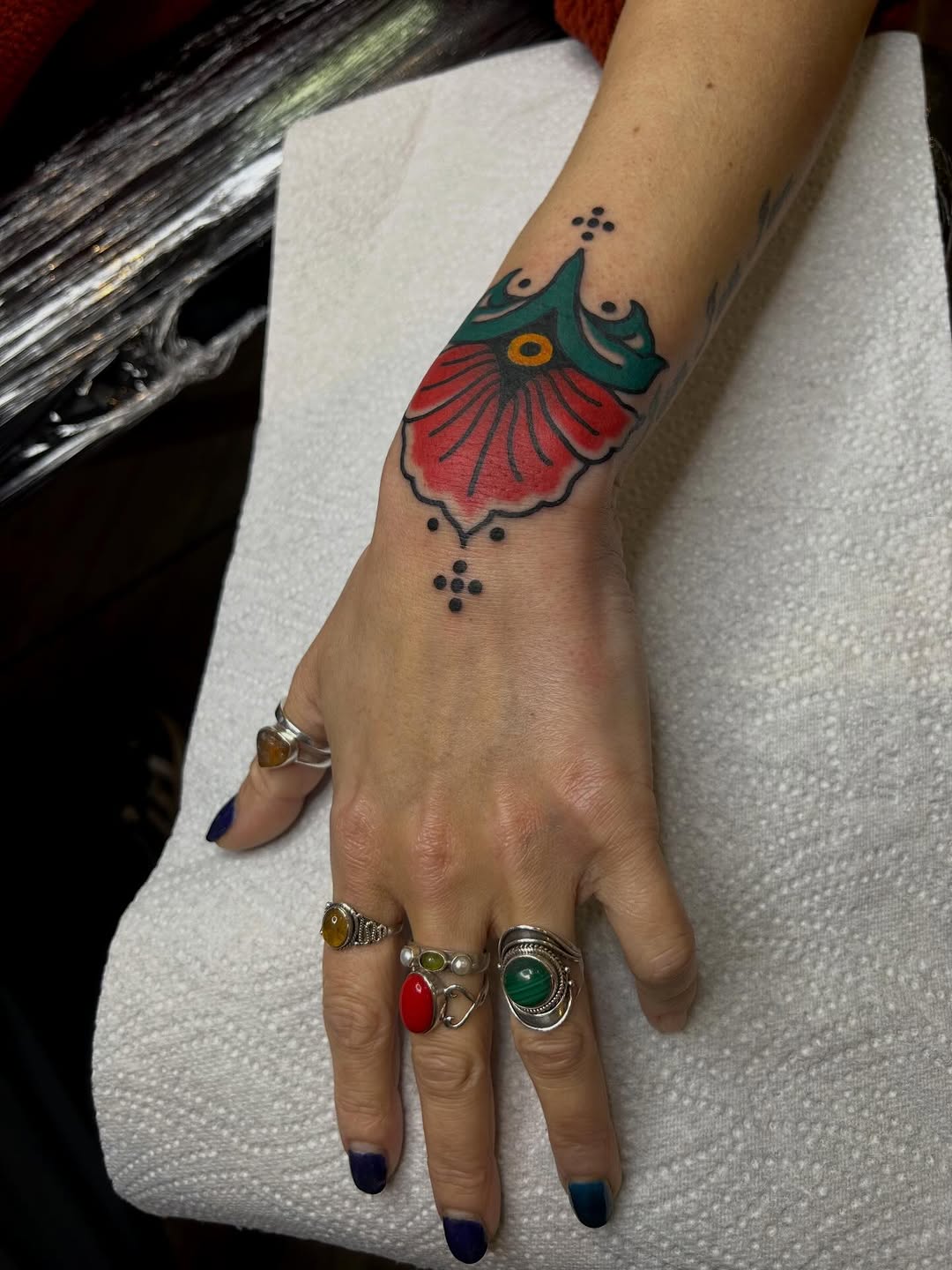 Bold neo-traditional floral wrist ornament with dots