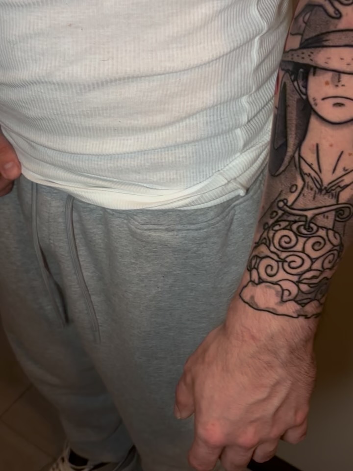Anime forearm piece featuring Luffy with ornate cloudwork