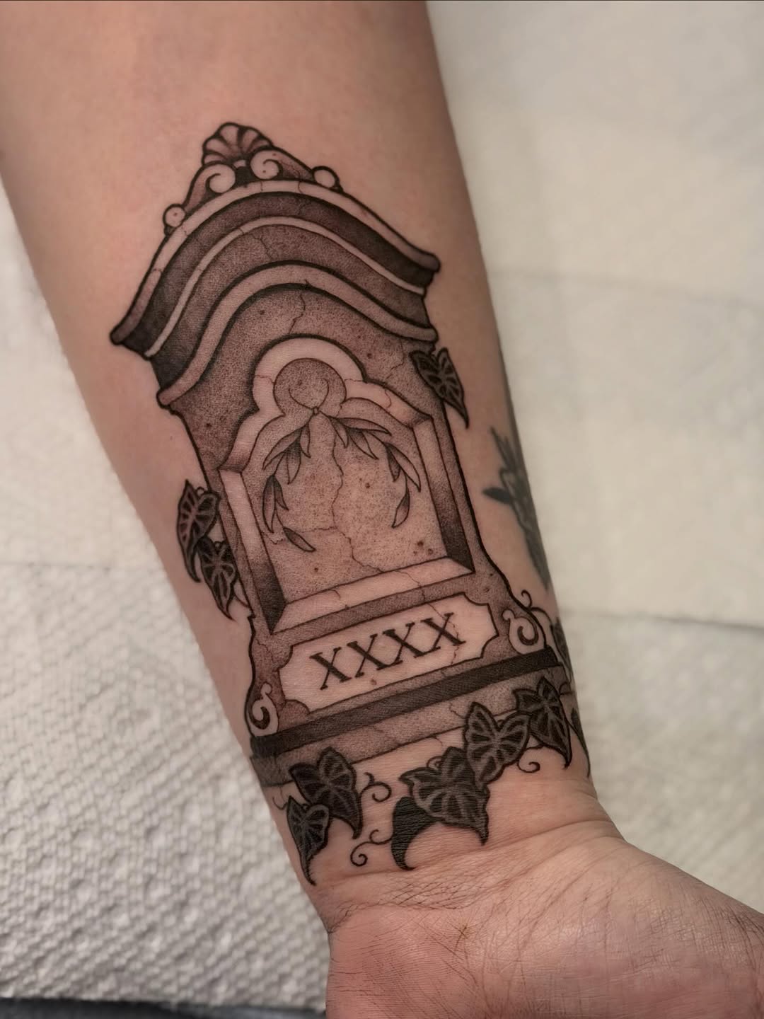 Gothic tombstone centerpiece with ivy, bold blackwork lines.