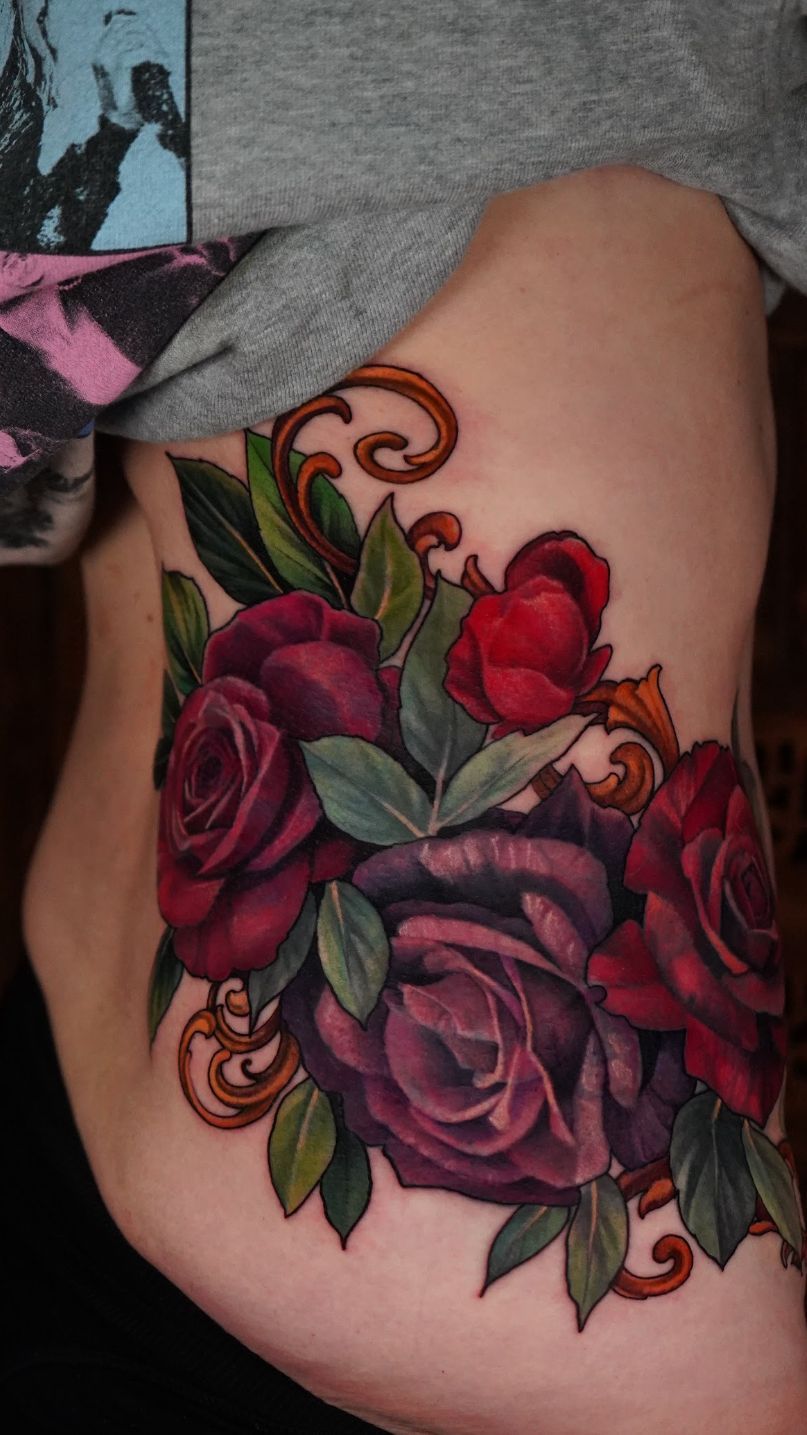 Vibrant neo-traditional rose bouquet with ornate scrollwork.