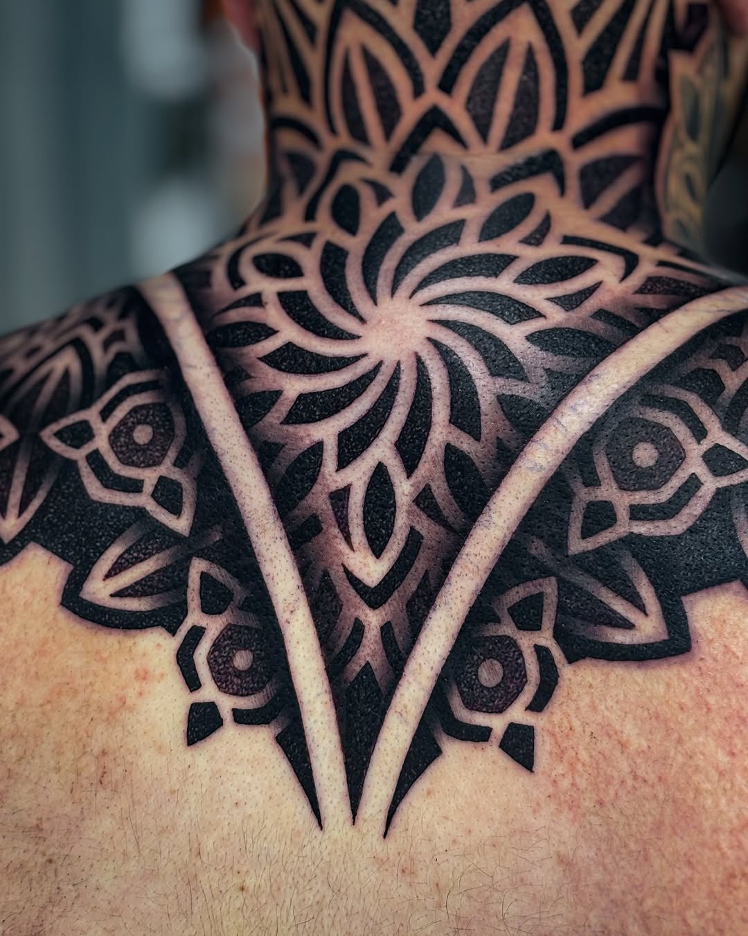 Intricate dotwork mandala with bold, negative-space spokes