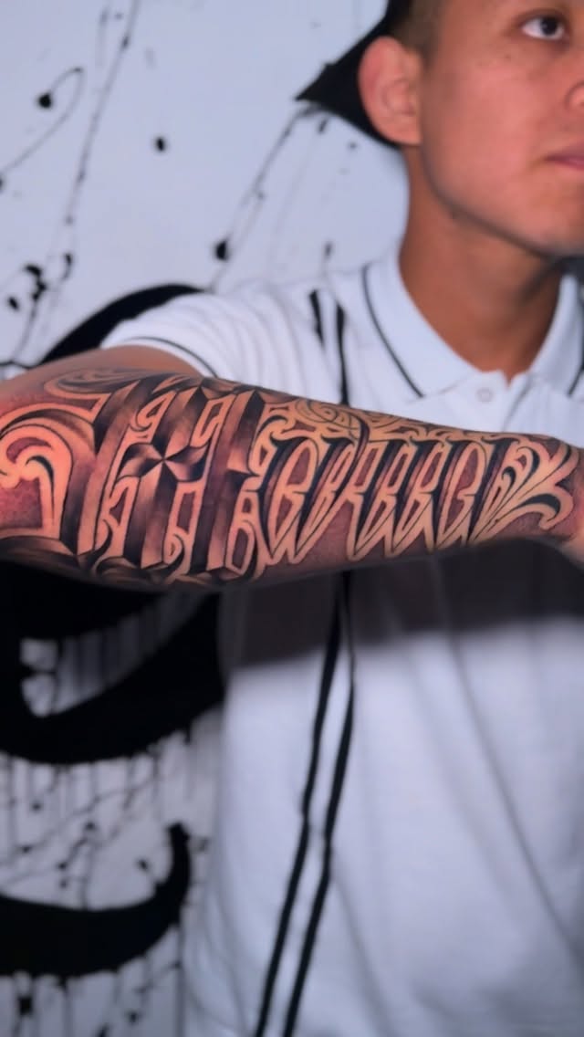 Intricate blackletter lettering with bold ornate swashes