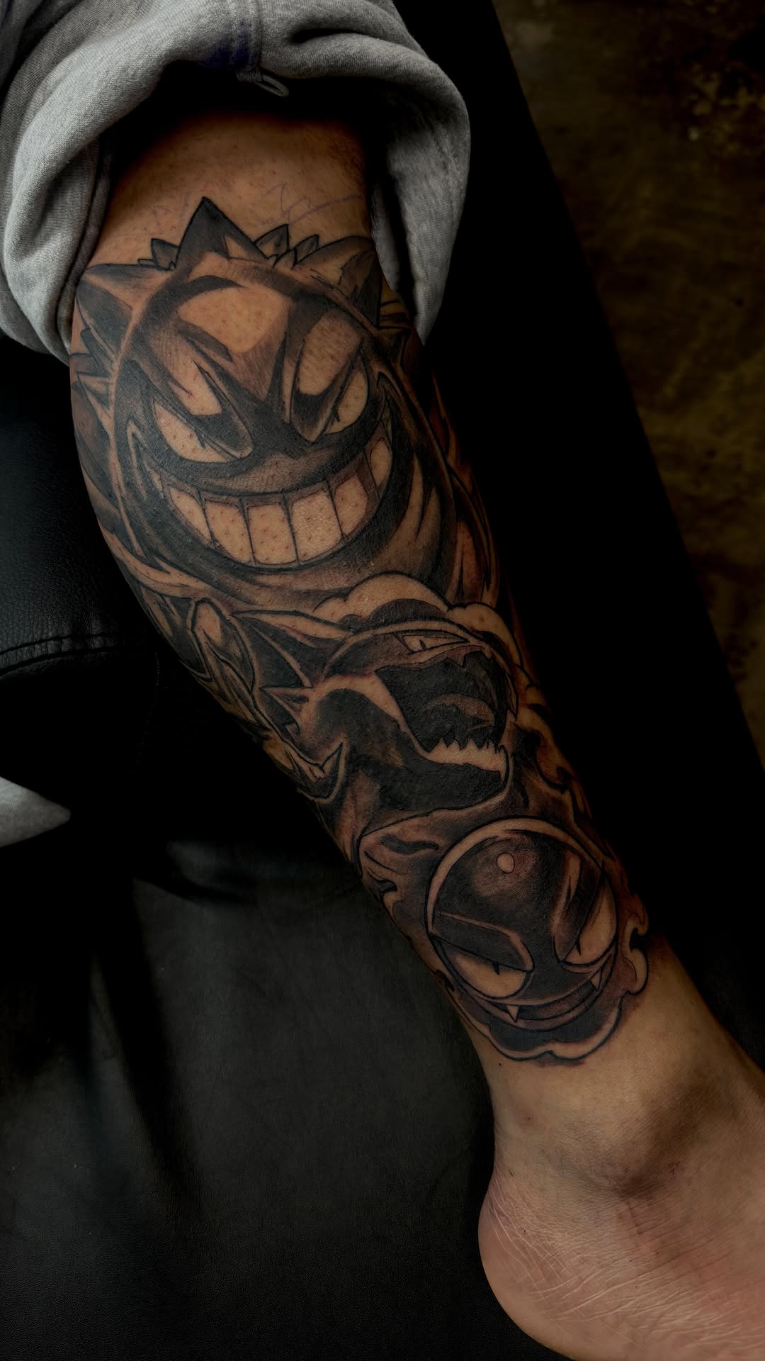 Bold black-line cartoon monsters wrap the lower leg