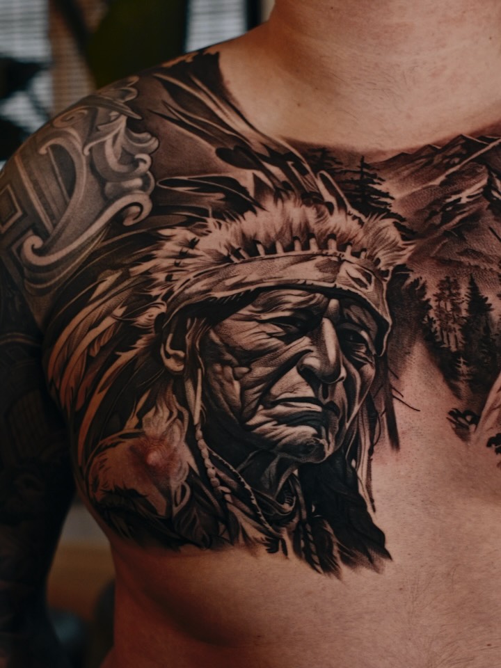 Hyper-detailed black-and-gray Native chief portrait across chest.